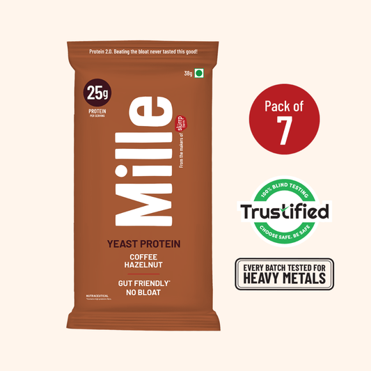 A single Mille Yeast Protein bar package in brown stands on a light beige background, with a red circle indicating 'Pack of 7' and Trustified and heavy metal testing badges to the right.