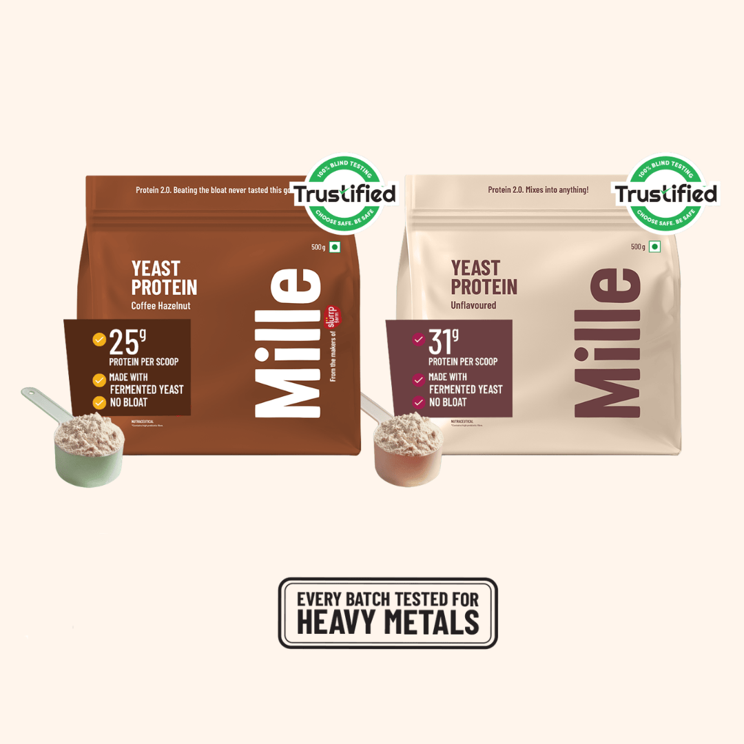 Two bags of Mille Yeast Protein powder by Trustified are shown side by side on a light beige background. The left bag is dark brown and labeled 'Mille Coffee Flavour' with 25g protein per scoop, and the right bag is light beige and labeled 'Mille Delightful' with 31g protein per scoop.