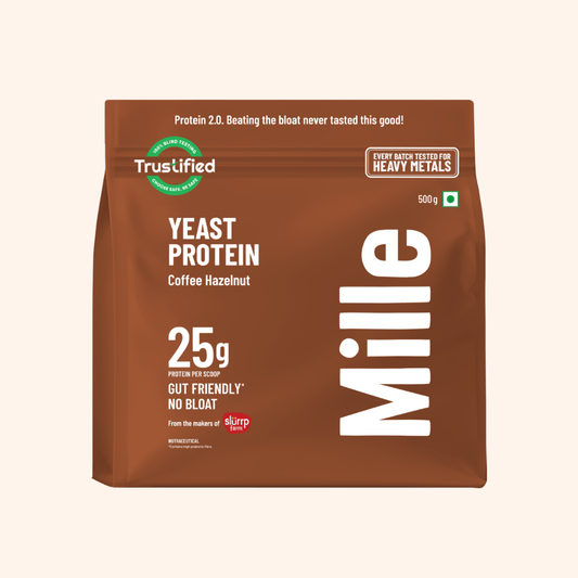 A 500g bag of Mille Yeast Protein Coffee Hazelnut in brown packaging with white text and green and red accents, shown on a light beige background.