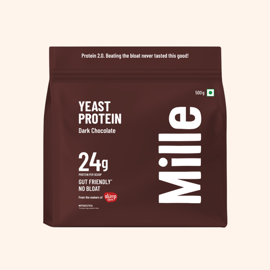 A 500g stand-up pouch of Mille Yeast Protein Dark Chocolate on a light beige background. The packaging is dark brown with white text and a small red Skaro logo.