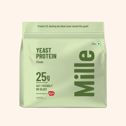 A 500g stand-up pouch of Mille Yeast Protein Chaas on a light beige background. The packaging is a pale sage green with dark green text and a small red 'duper' logo near the bottom.